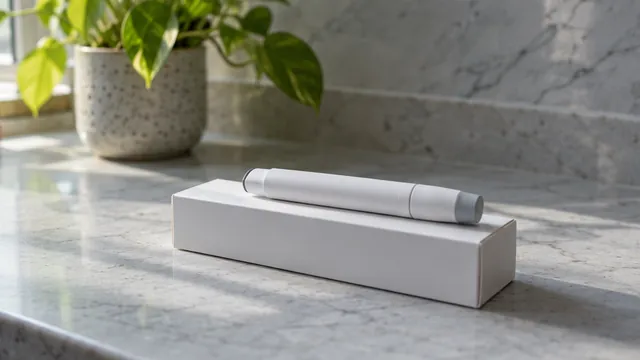 An injection pen resting on its carton on a marble counter